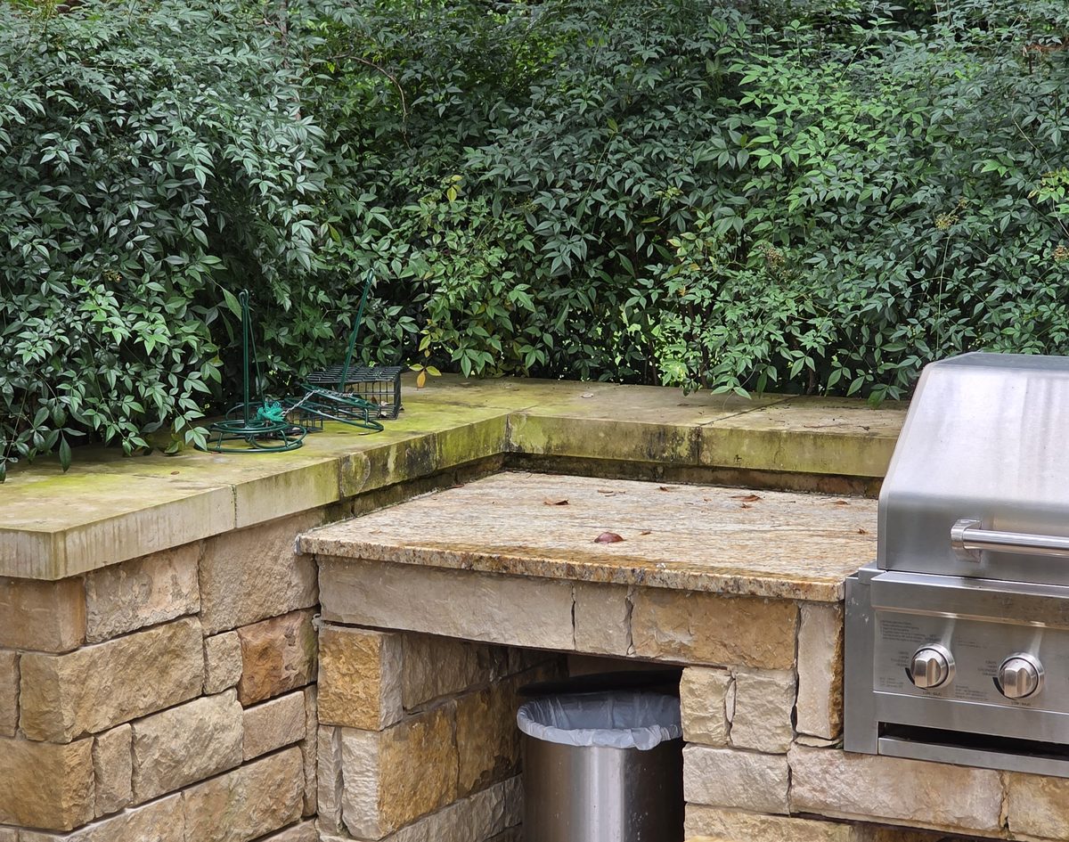Stone outdoor kitchen with algae growth