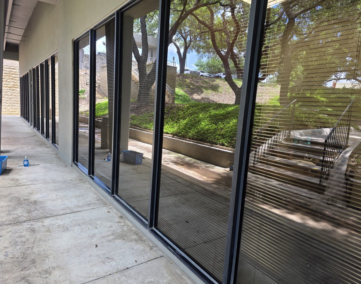 A long run of storefront glass after a wash