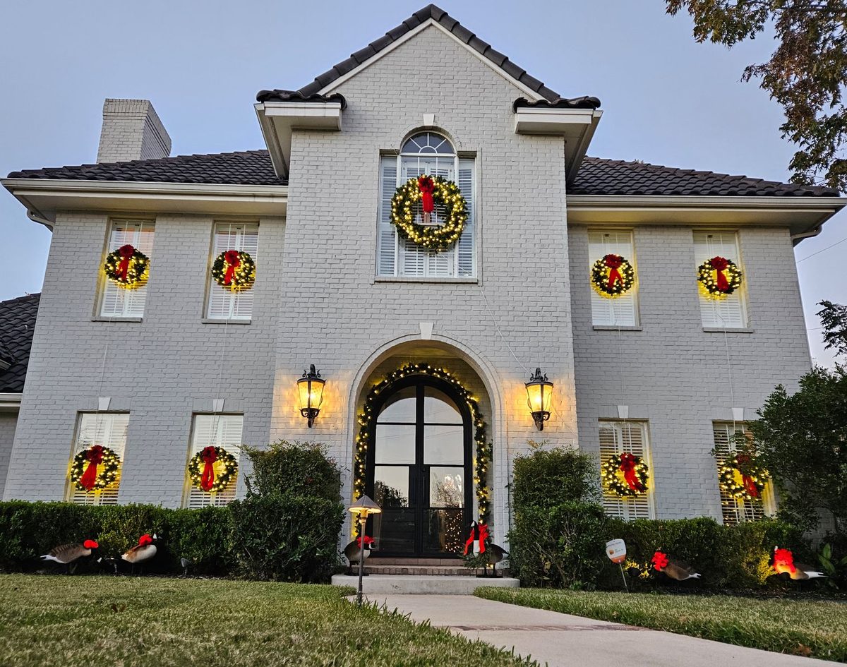 Wreaths in every window of a brick home